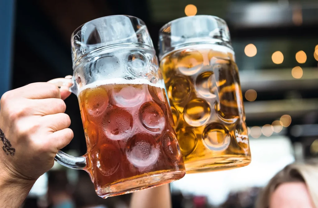 Two beer steins raised in a toast