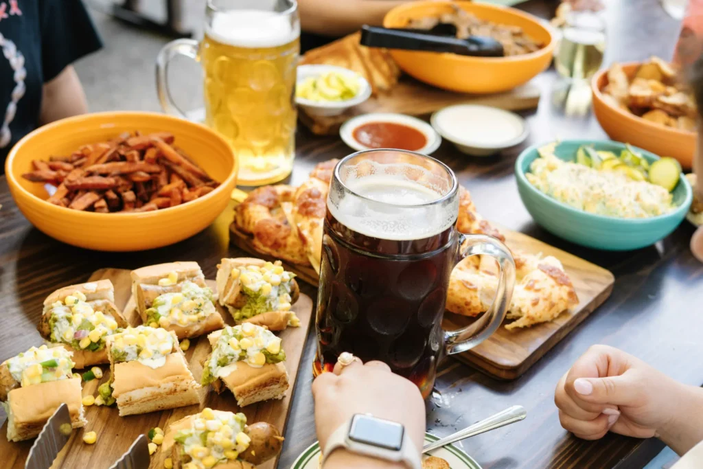 Shared appetizers and beer spread across a table